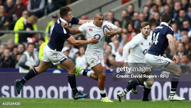 Jonathan Joseph of England is tackled by Huw Jones during the RBS Six Nations match between England and Scotland at Twickenham Stadium on March 11,...