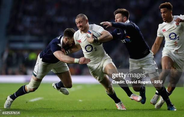 Mike Brown of England is tackled by Ali Price and Alex Dunbar during the RBS Six Nations match between England and Scotland at Twickenham Stadium on...