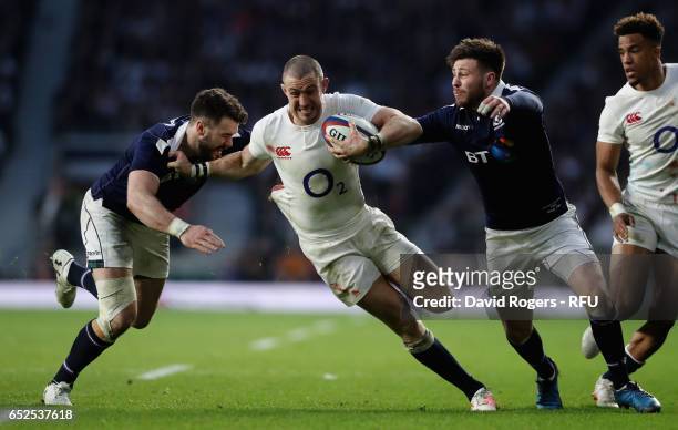 Mike Brown of England is tackled by Ali Price and Alex Dunbar during the RBS Six Nations match between England and Scotland at Twickenham Stadium on...