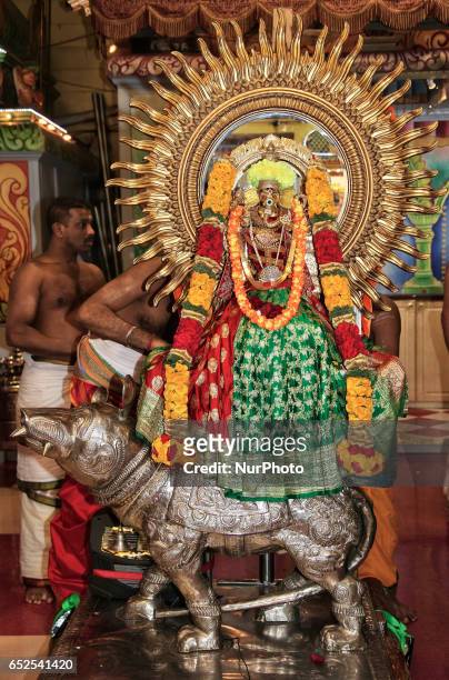 Tamil Hindu devotees place the idol of Lord Ganesh atop his mouse vahana in preparation for a religious procession during the Masi Magam Festival at...