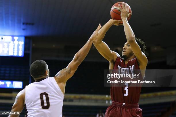 Wesley Person of the Troy Trojans shoots over Bobby Conley of the Texas State Bobcats during the first half of a game in the final round of the Sun...