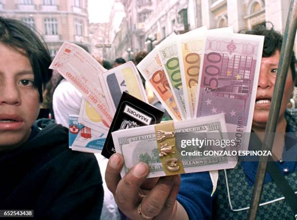 Vendors sell miniature replicas of money and passports for the Festival of Alasitas. Una vendedora de miniaturas exhibe su mercaderia, el 24 de enero...