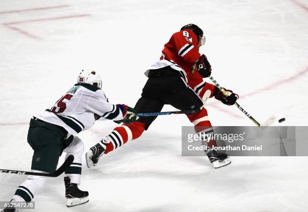 Marian Hossa of the Chicago Blackhawks scores a third period goal in front of Jonas Brodin of the Minnesota Wild at the United Center on March 12,...