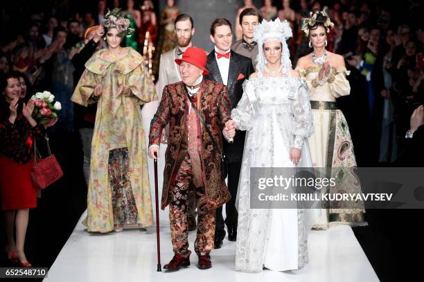 Russian designer Slava Zaitsev smiles after presenting his creations at the Mercedes-Benz Fashion Week Russia in Moscow on March 12, 2017.