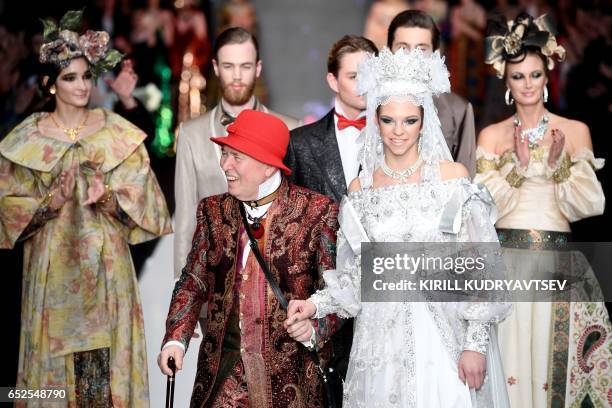 Russian designer Slava Zaitsev smiles after presenting his creations at the Mercedes-Benz Fashion Week Russia in Moscow on March 12, 2017.