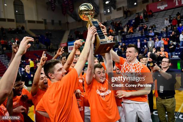 Spencer Weisz of the Princeton Tigers is the first to hoist the trophy for the crowd after the win against the Yale Bulldogs in the Ivy League...