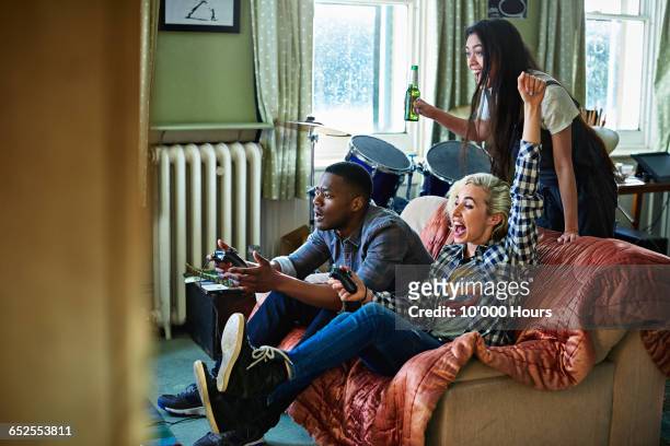 friends playing games console - game three stockfoto's en -beelden