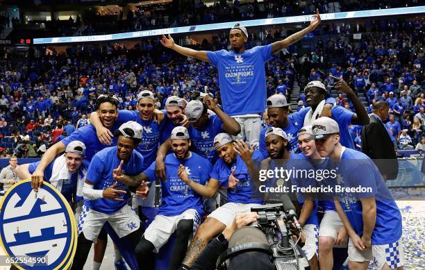 The Kentucky Wildcats pose for photos after an 82-65 victory over Arkansas to win the SEC Tournament Champion Game at Bridgestone Arena on March 12,...