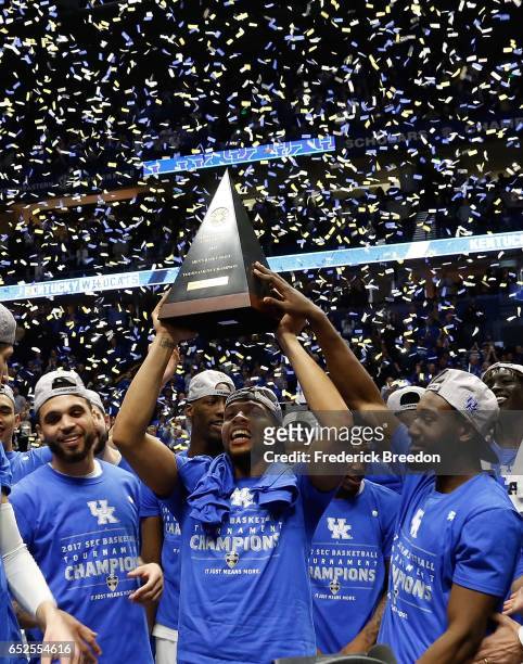 Isaiah Briscoe of the Kentucky Wildcats holds up the SEC Championship trophy after an 82-65 Kentucky victory over Arkansas to win the SEC Tournament...