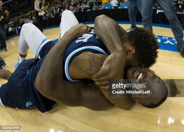 Jarvis Garrett and Jared Terrell of the Rhode Island Rams celebrate after the game against the Virginia Commonwealth Rams in the Championship game of...