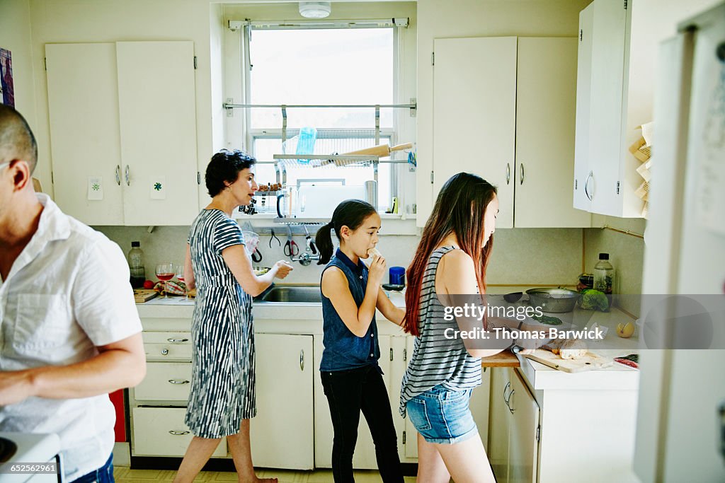 Family preparing dinner together in home kitchen