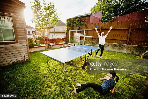 father celebrating point during ping pong game - funny ping pong stock pictures, royalty-free photos & images