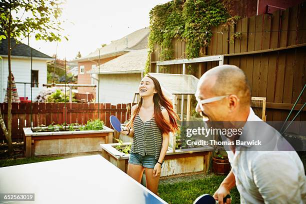 laughing father and daughter playing ping pong - funny ping pong stock-fotos und bilder