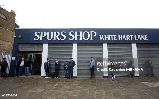 Fans stand outside the closed Spurs Shop ahead of The Emirates FA Cup Quarter-Final match between Tottenham Hotspur and Millwall at White Hart Lane...