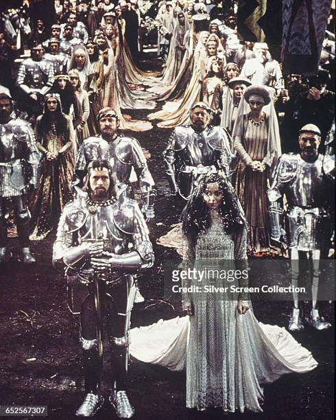 Nigel Terry as King Arthur, Cherie Lunghi as Guenevere, with Patrick Stewart and Clive Swift behind them in the film 'Excalibur'