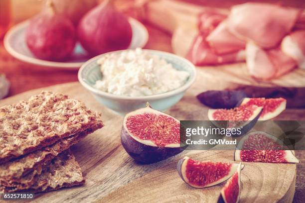 crispbread with serrano ham, cottage cheese, and figs - knäckebrot stock pictures, royalty-free photos & images