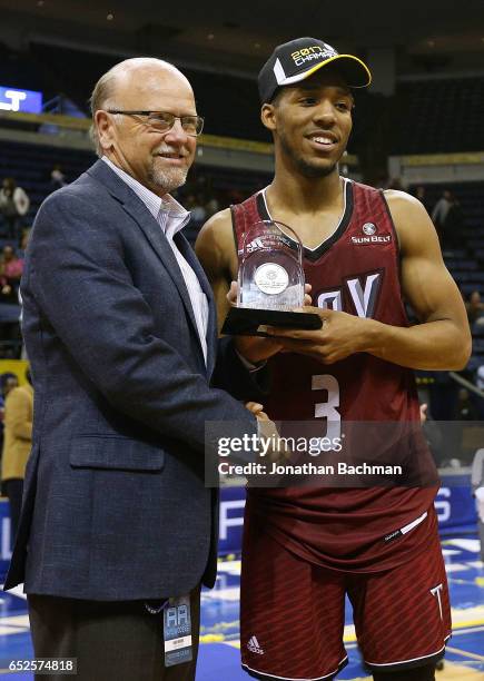 Karl Benson commissioner of the Sun Belt Conference presents the mvp award to Wesley Person of the Troy Trojans after the championship game of the...