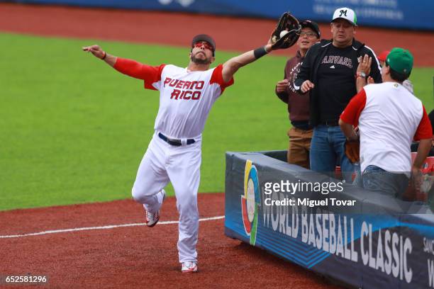 Mike Aviles of Puerto Rico catches a pop fly in the top of the third inning during the World Baseball Classic Pool D Game 5 between Italy and Puerto...