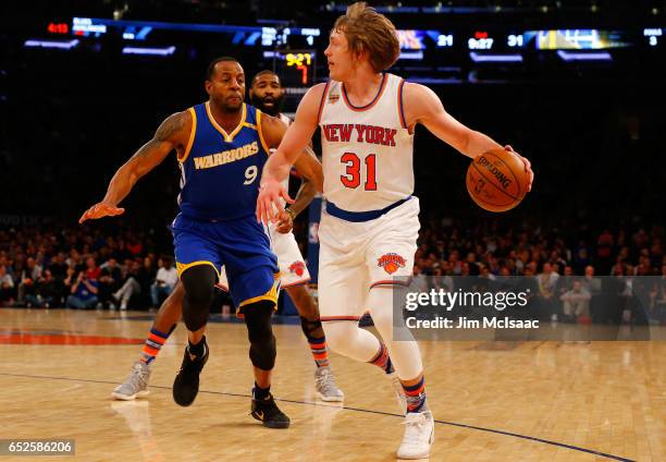 Ron Baker of the New York Knicks in action against Andre Iguodala of the Golden State Warriors at Madison Square Garden on March 5, 2017 in New York...