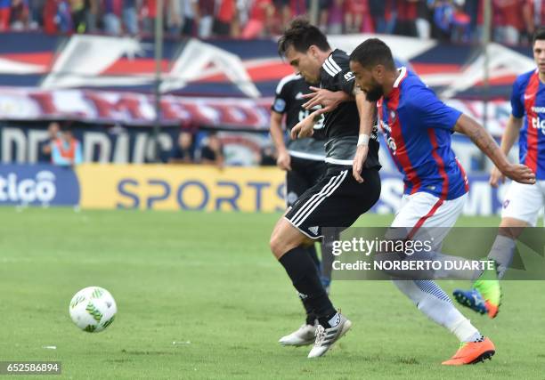 Olimpia's Paulo Mouche vies for the ball with Alvaro Pereira of Cerro Porteno during their Paraguayan apertura 2017 tournament match at the...