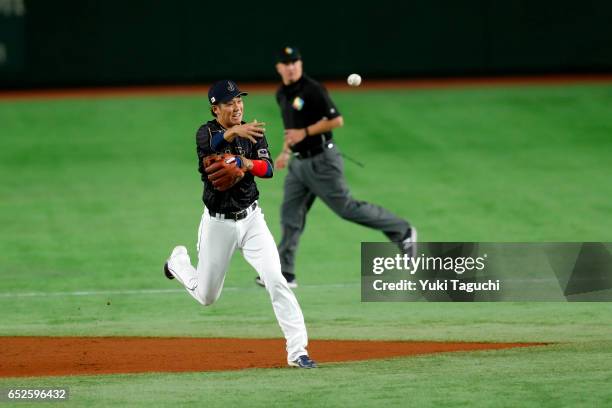 Hayato Sakamoto of Team Japan throws to first base in the first inning during Game 2 of Pool E of the 2017 World Baseball Classic against Team...