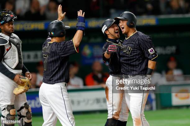 Sho Nakata, Ryosuke Kikuchi and Norichika Aoki of Team Japan celebrate after hitting a three run home run in the third inning during Game 2 of Pool E...