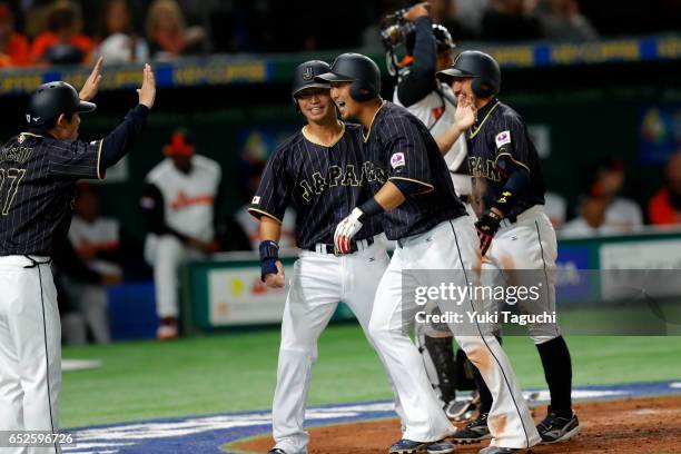 Sho Nakata, Ryosuke Kikuchi and Norichika Aoki of Team Japan celebrate after a three run home run in the third inning during Game 2 of Pool E of the...