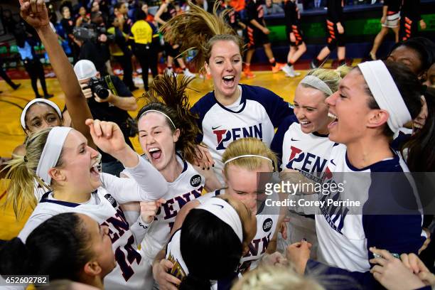 The Pennsylvania Quakers women's basketball team celebrates their win over the Princeton Tigers in the Ivy League tournament final at The Palestra on...