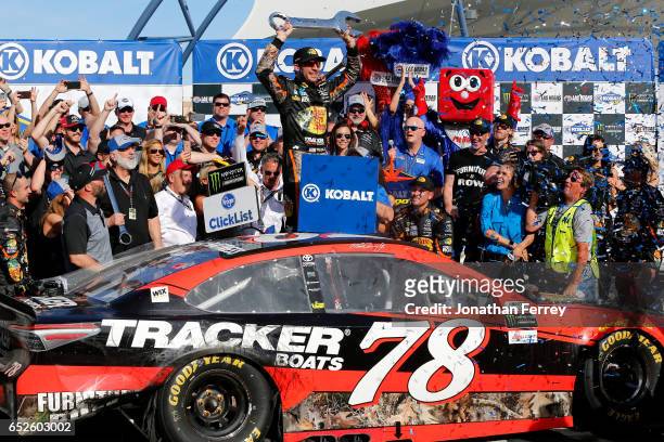 Martin Truex Jr., driver of the Bass Pro Shops/TRACKER BOATS Toyota, celebrates in Victory Lane after winning the Monster Energy NASCAR Cup Series...