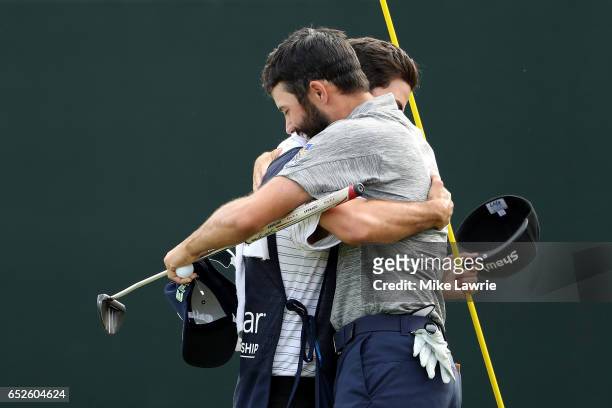 Adam Hadwin of Canada celebrates with his caddie on the 18th green after winning the Valspar Championship during the final round at Innisbrook Resort...