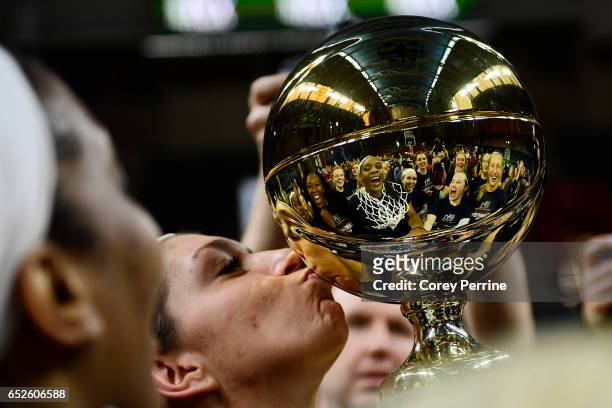 Jackie Falconer of the Pennsylvania Quakers kisses the championship trophy as the team is reflected after the win against the Princeton Tigers in the...
