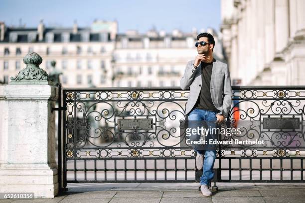 Anil Brancaleoni, Youtube influencer Wartek and blogger, wears Bobbies gray suede shoes, Replay blue denim jeans pants, a Replay t-shirt, sunglasses,...