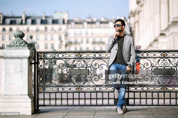 Anil Brancaleoni, Youtube influencer Wartek and blogger, wears Bobbies gray suede shoes, Replay blue denim jeans pants, a Replay t-shirt, sunglasses,...