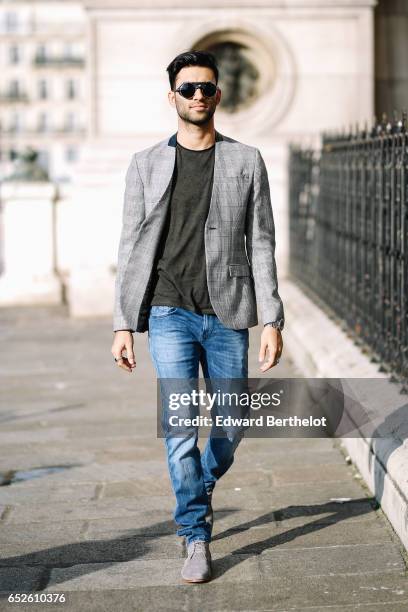 Anil Brancaleoni, Youtube influencer Wartek and blogger, wears Bobbies gray suede shoes, Replay blue denim jeans pants, a Replay t-shirt, sunglasses,...