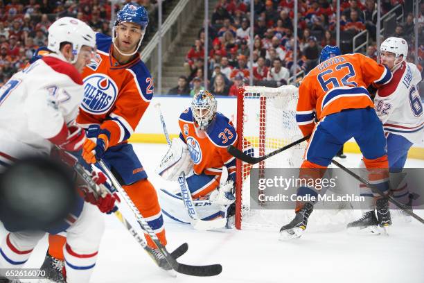 Darnell Nurse and goalie Cam Talbot of the Edmonton Oilers keep their eyes on the puck as Alexander Radulov of the Montreal Canadiens looks for the...