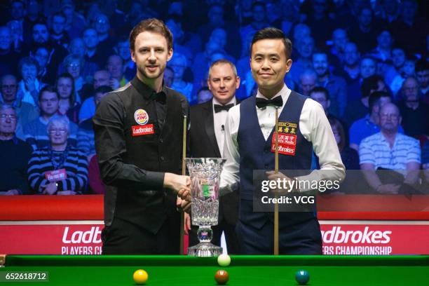 Judd Trump of England shakes hands with Marco Fu of Chinese Hong Kong during the final match on day seven of 2017 Ladbrokes Players Championship at...