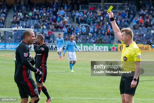 Midfielder Nick DeLeon of D.C. United receives a yellow card during the match vs New York City FC at Yankee Stadium on March 12, 2017 in New York...