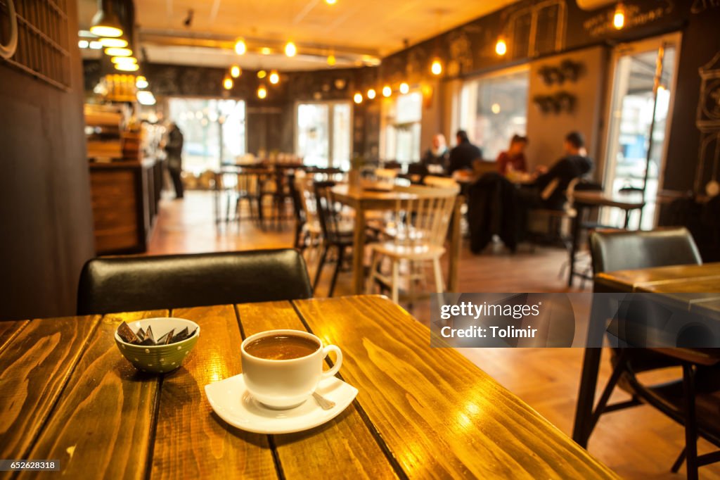 Caffee on table and blured cafe