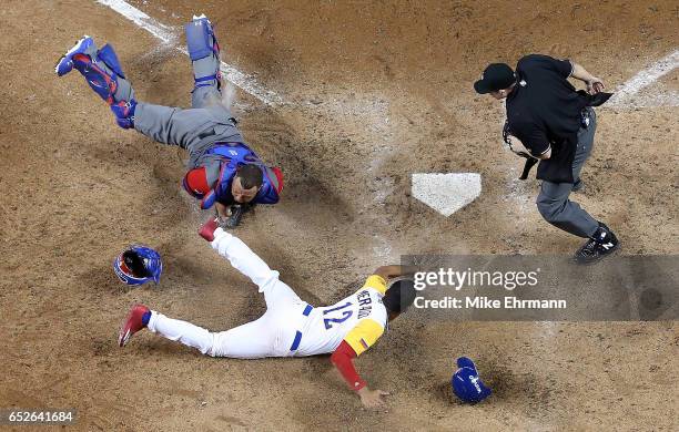 Welington Castillo of the Dominican Republic tags out Oscar Mercado of Colombia at home in the ninth inning during a Pool C game of the 2017 World...