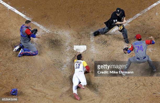 Welington Castillo of the Dominican Republic tags out Oscar Mercado of Colombia at home in the ninth inning during a Pool C game of the 2017 World...