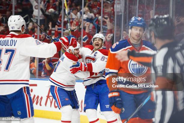 Adam Larsson of the Edmonton Oilers reacts as Alexander Radulov, Alex Galchenyuk and Max Pacioretty of the Montreal Canadiens celebrate a goal on...
