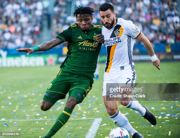 Romain Alessandrini of Los Angeles Galaxy battles Alvas Powell of Portland Timbers during Los Angeles Galaxy's MLS match against Portland Timbers at...