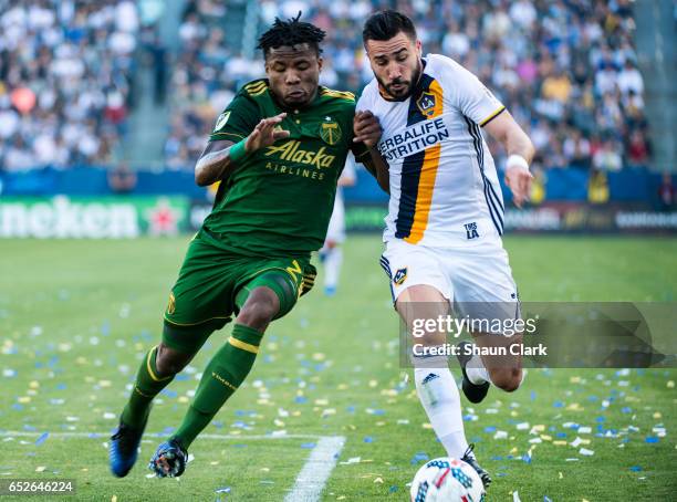 Romain Alessandrini of Los Angeles Galaxy battles Alvas Powell of Portland Timbers during Los Angeles Galaxy's MLS match against Portland Timbers at...