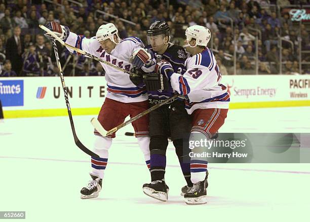 Ziggy Palffy of the Los Angeles Kings is sandwiched by Tim Taylor and Johan Witehall of the New York Rangers during the first period at Staples...