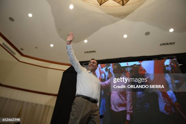 Opposition candidate of the Liberty Party, Luis Zelaya, waves to supporters after declaring victory in the primary elections in Tegucigalpa, on March...