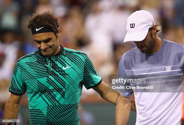Roger Federer of Switzerland shakes hands at the net after his straight sets victory against Stephane Robert of France in their second round match...