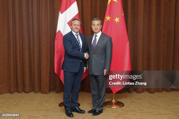 Chinese Foreign Minister Wang Yi shakes hands with Denmark's Foreign Minister Anders Samuelsen before during their meeting at the Ministry of Foreign...