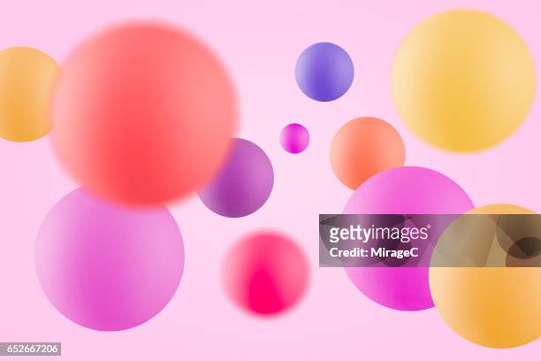 multi-colored balls in mid air - rebote fotografías e imágenes de stock