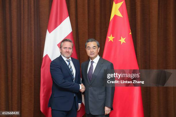 Chinese Foreign Minister Wang Yi shakes hands with Denmark's Foreign Minister Anders Samuelsen before during their meeting at the Ministry of Foreign...