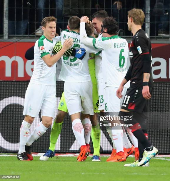 Goalkeeper Felix Wiedwald of Werder Bremen holds the penalty of Oemer Toprak of Leverkusen during the Bundesliga soccer match between Bayer...